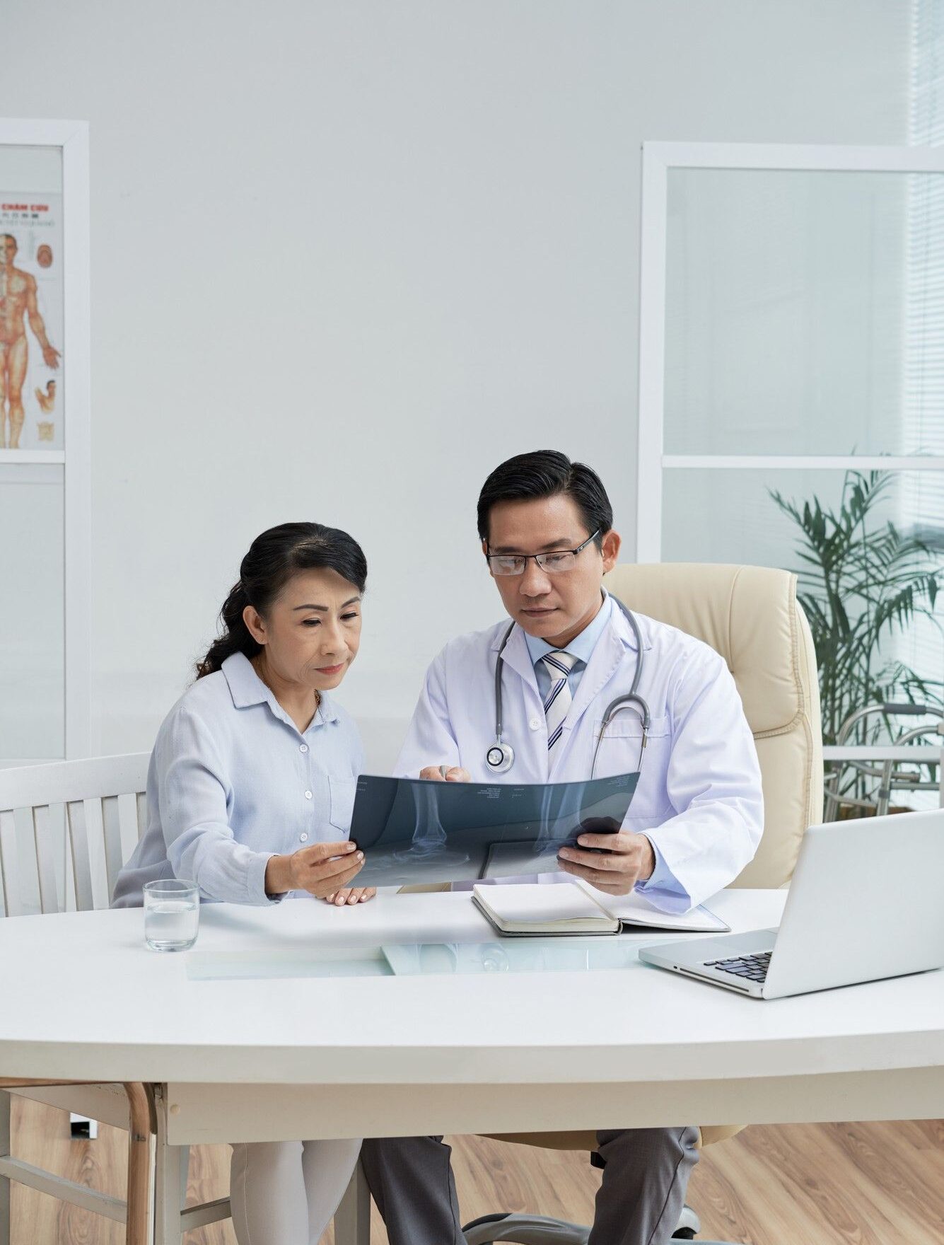 A Doctor And Patient Discuss Health Matters At A Table