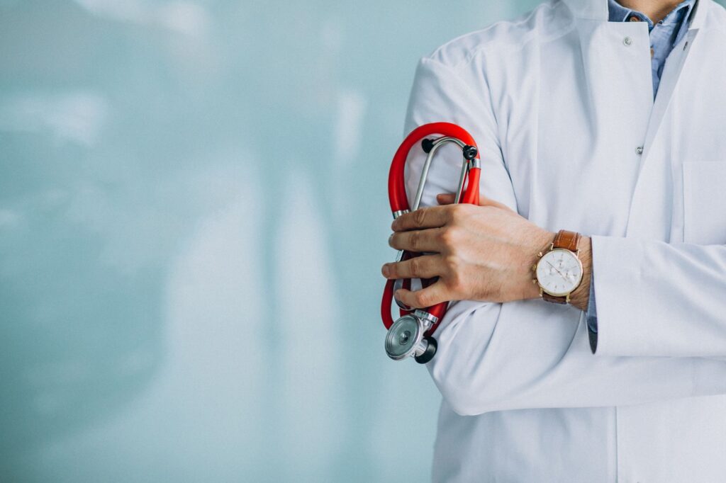 A Doctor In A White Coat Holds A Stethoscope, Ready To Examine A Patient