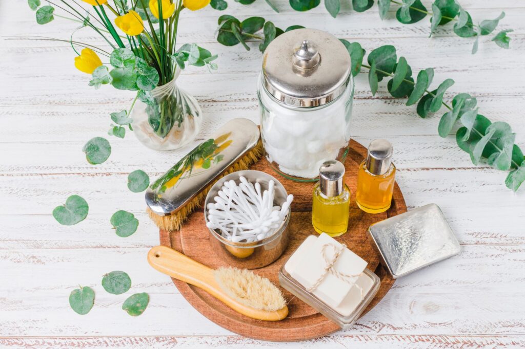 A Wooden Tray Displaying A Bar Of Soap, A Toothbrush, And Various Personal Care Items Arranged Neatly